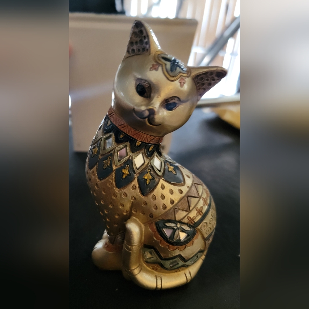Vintage brass and ceramic cat decoration with glass accents